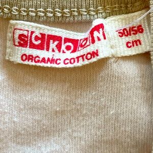 Brand new tagged 100% organic cotton Sckoon 0-3 months infant onesie.